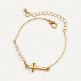 Golden bracelet with cross and pearls
