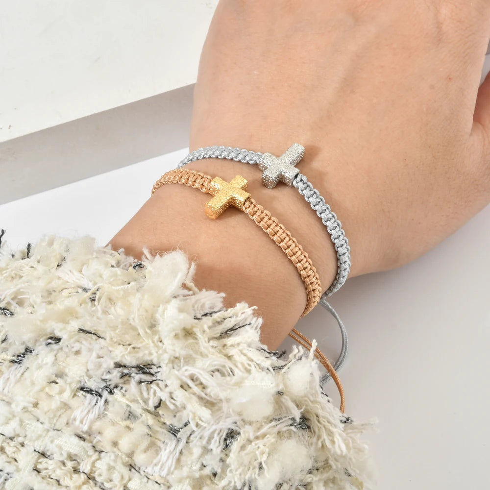 Adjustable braided bracelet with cross charm