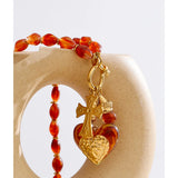 Collier Rouge Translucide à Breloques Croix et Cœur