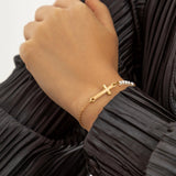 Golden bracelet with cross and pearls