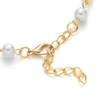 Armband mit Perlen aus Muschel und Kreuzanhänger